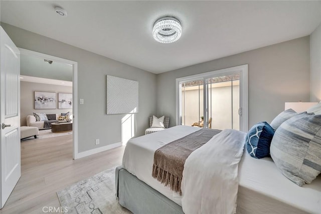 bedroom featuring light wood-type flooring, access to outside, and baseboards