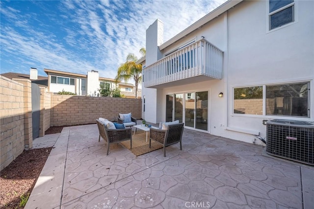 view of patio with a balcony, a fenced backyard, an outdoor hangout area, and cooling unit