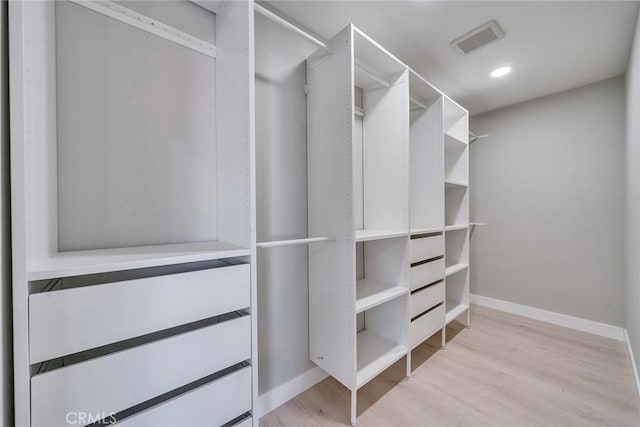 spacious closet with light wood-type flooring and visible vents