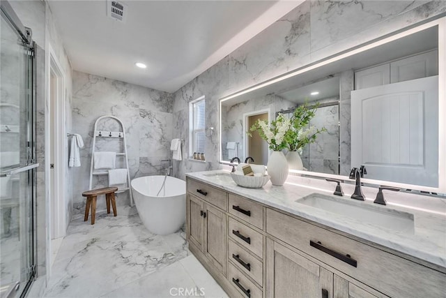 full bathroom featuring marble finish floor, a marble finish shower, double vanity, a sink, and stone wall