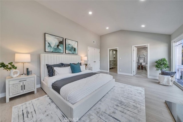 bedroom featuring light wood finished floors, lofted ceiling, recessed lighting, connected bathroom, and baseboards