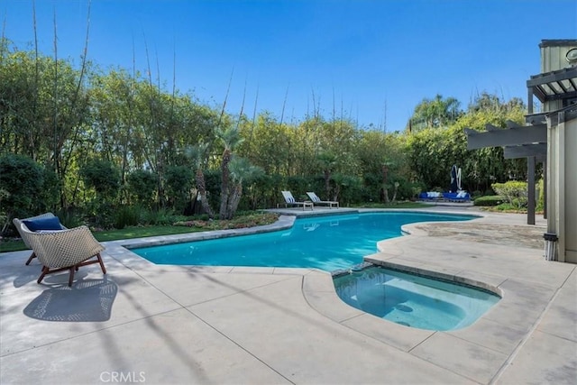 view of swimming pool featuring a pool with connected hot tub and a patio