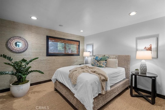 bedroom featuring an accent wall and recessed lighting