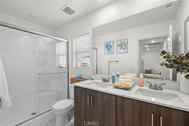 bathroom with double vanity, ensuite bath, visible vents, and a sink