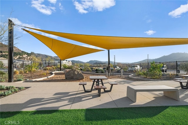 view of home's community featuring fence and a mountain view