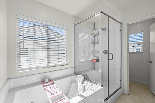 bathroom with tile patterned floors, a shower stall, and a bath