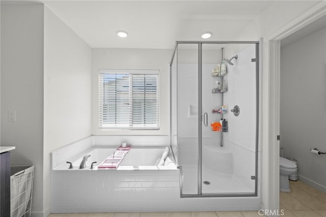 bathroom featuring toilet, a garden tub, a shower stall, and tile patterned floors