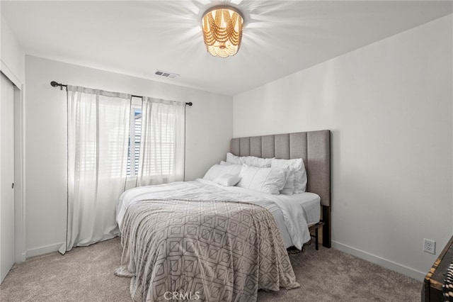 bedroom with light carpet, visible vents, and baseboards