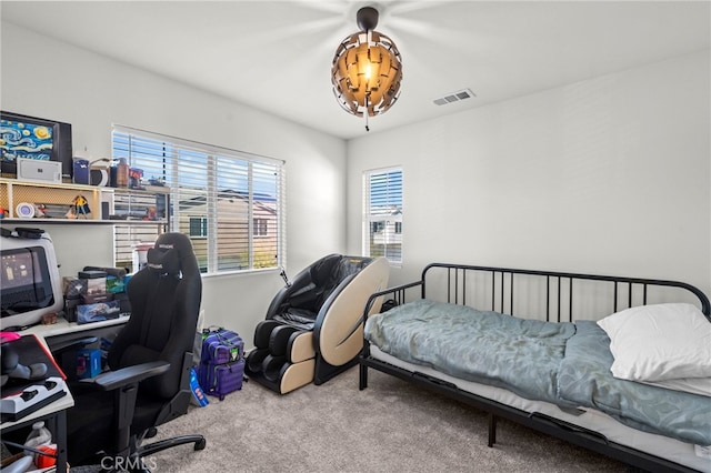 carpeted bedroom featuring visible vents