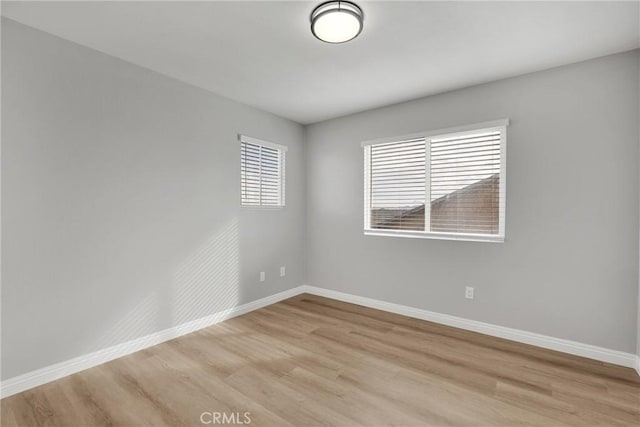 unfurnished room featuring light wood-style floors and baseboards