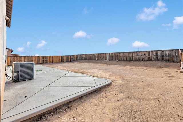 view of yard featuring a fenced backyard, cooling unit, and a patio