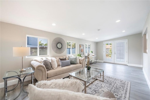 living room featuring french doors, recessed lighting, vaulted ceiling, wood finished floors, and baseboards