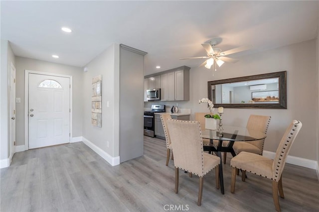 dining room featuring light wood-type flooring, baseboards, and recessed lighting