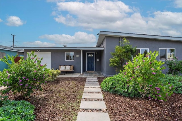 view of front of home with an attached garage and stucco siding