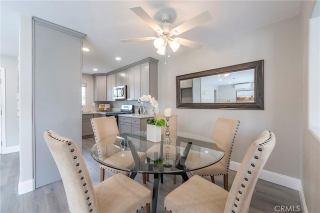 dining area with ceiling fan, recessed lighting, light wood-type flooring, and baseboards