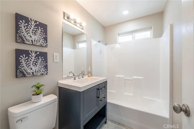 bathroom with toilet, shower / washtub combination, and vanity