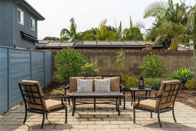 view of patio / terrace featuring an outdoor hangout area and fence