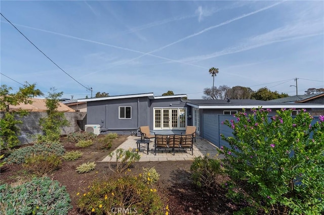 rear view of house with a patio, fence, french doors, ac unit, and stucco siding