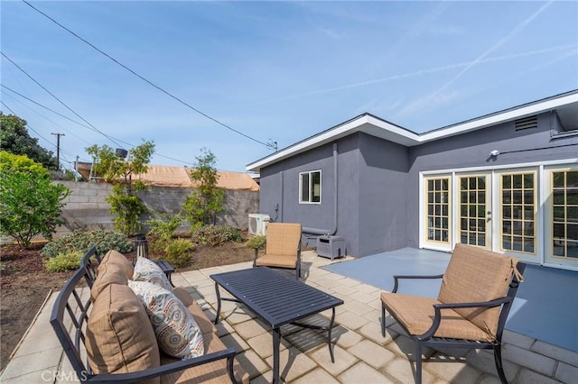 view of patio featuring french doors, a fenced backyard, and an outdoor living space