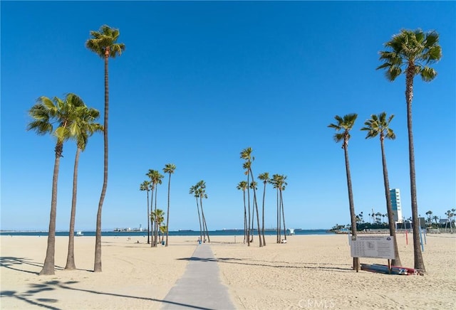 surrounding community with a water view and a view of the beach