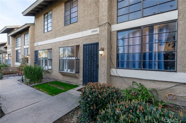 property entrance with stucco siding