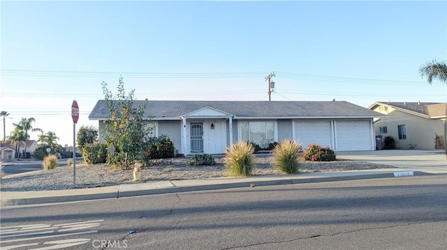 single story home featuring an attached garage and concrete driveway