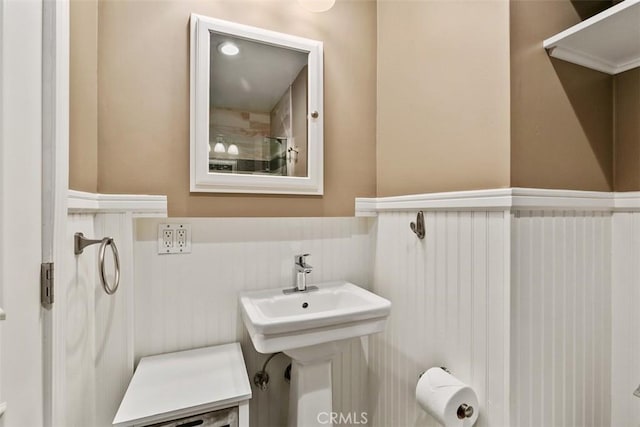 bathroom with a wainscoted wall