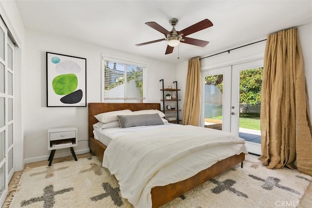 bedroom featuring baseboards, french doors, multiple windows, and access to exterior