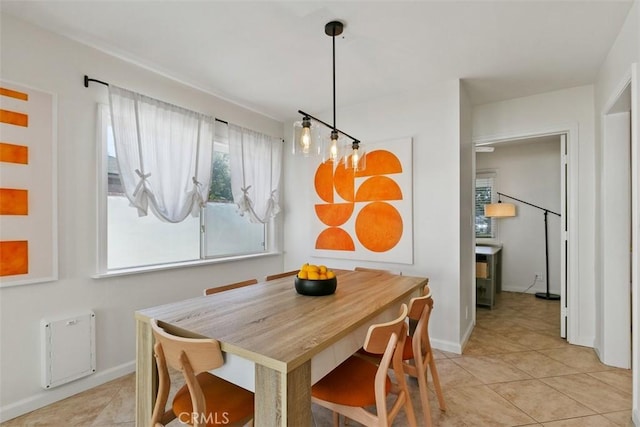 dining room with light tile patterned floors and baseboards