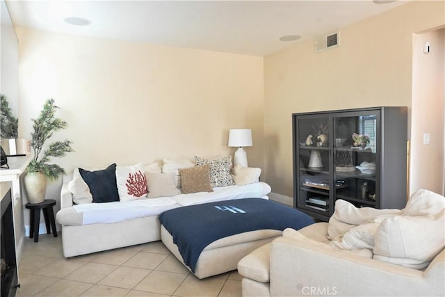 living area featuring light tile patterned floors and visible vents