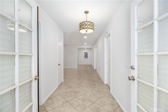 hall with recessed lighting, baseboards, and light tile patterned floors