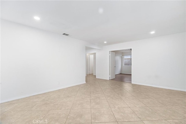 unfurnished room with light tile patterned floors, recessed lighting, visible vents, and baseboards