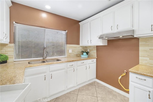 kitchen featuring a sink, white cabinets, and under cabinet range hood