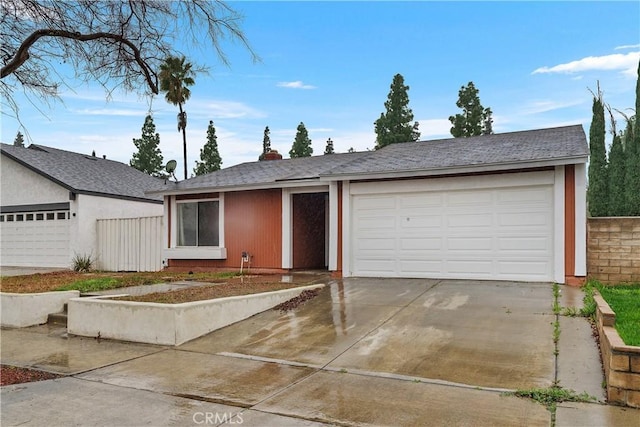 ranch-style house featuring a garage and driveway