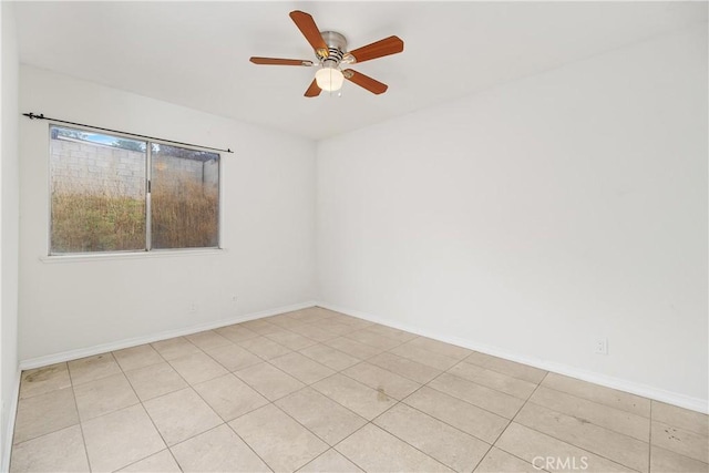 unfurnished room featuring a ceiling fan and baseboards