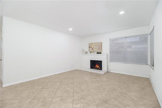 unfurnished living room with recessed lighting, a fireplace, baseboards, and light tile patterned floors