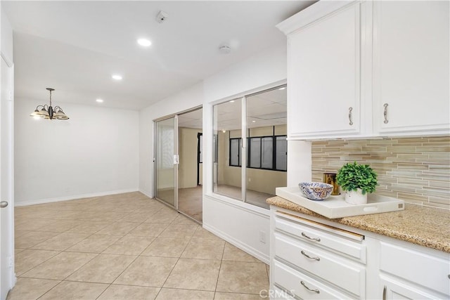 kitchen featuring pendant lighting, tasteful backsplash, recessed lighting, white cabinetry, and light tile patterned flooring