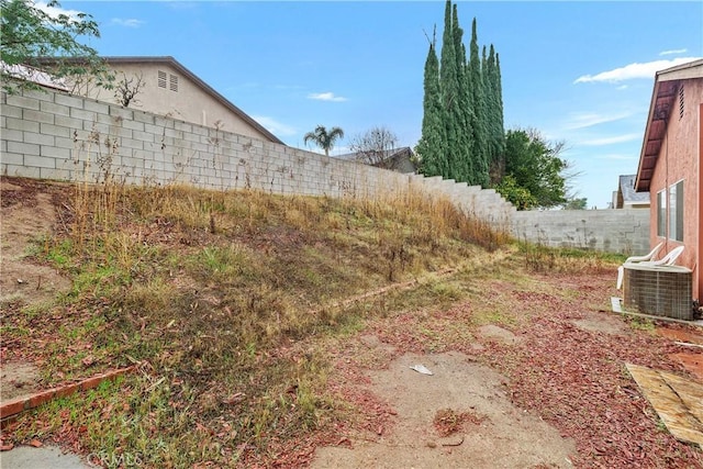 view of yard with a fenced backyard and cooling unit