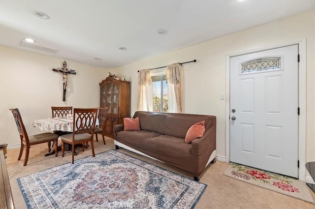 living room featuring light colored carpet, visible vents, baseboards, and recessed lighting