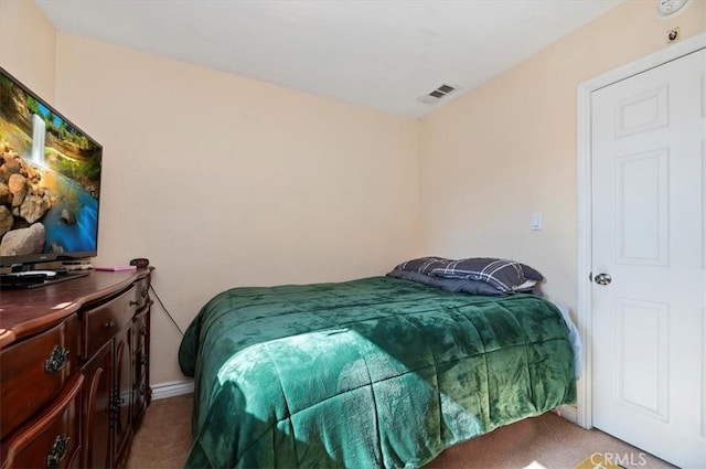 bedroom with baseboards, visible vents, and carpet flooring