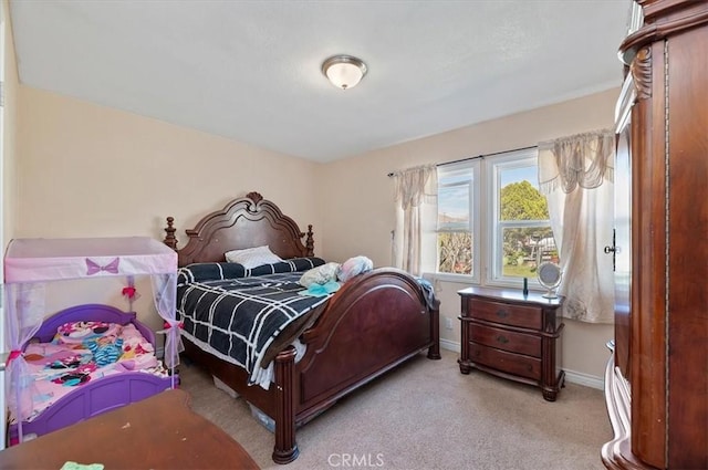 bedroom with light carpet and baseboards