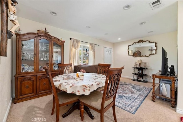 dining space featuring light carpet, baseboards, visible vents, and recessed lighting