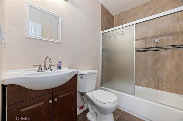 full bathroom with vanity, toilet, and bath / shower combo with glass door