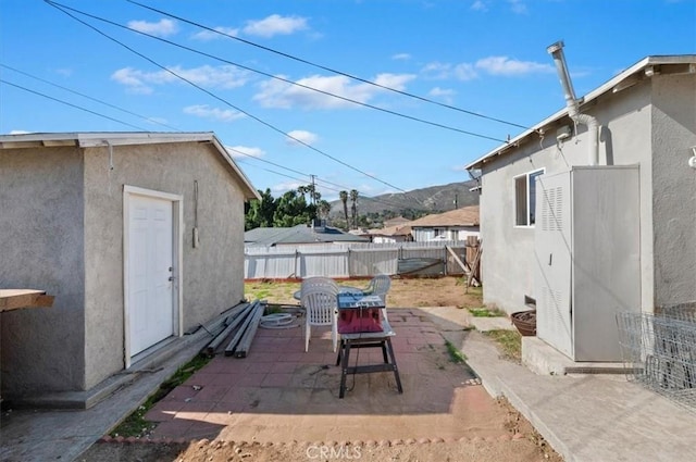 view of patio featuring an outbuilding and a fenced backyard