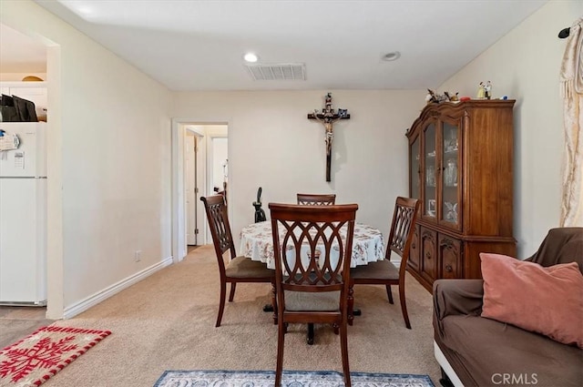 dining room featuring recessed lighting, visible vents, light carpet, and baseboards