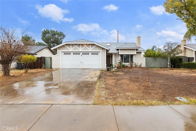 ranch-style house with a garage, fence, and concrete driveway