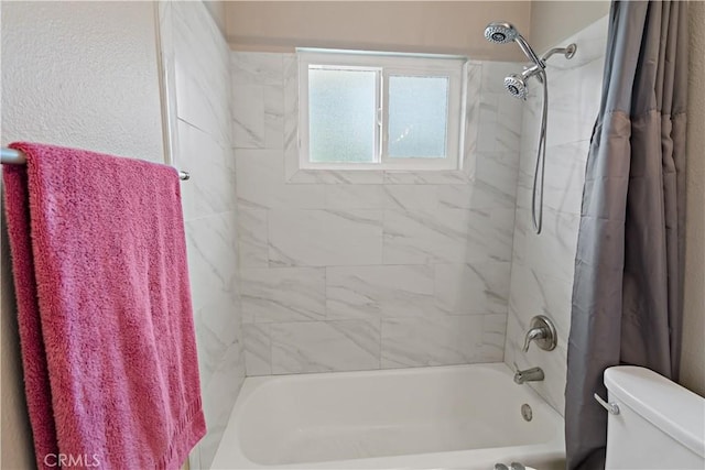 full bathroom featuring shower / tub combo and toilet