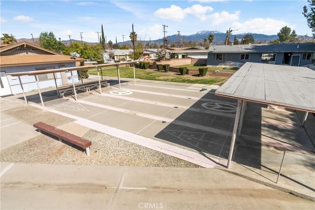 exterior space with a mountain view and shuffleboard