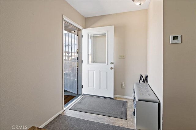 doorway featuring baseboards