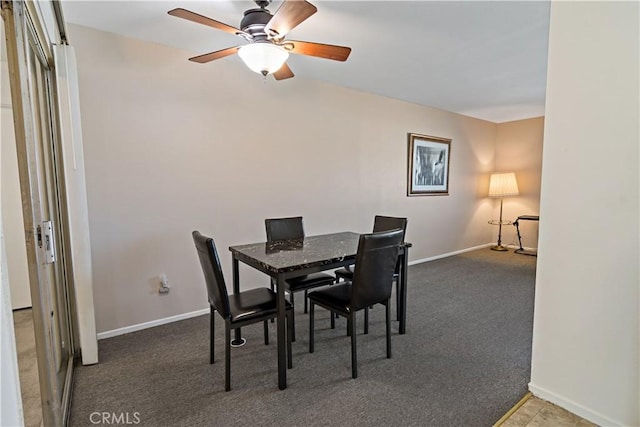 dining area featuring baseboards, ceiling fan, and carpet flooring